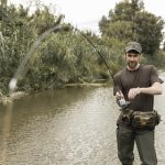 man fishing river