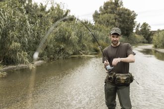 man fishing river